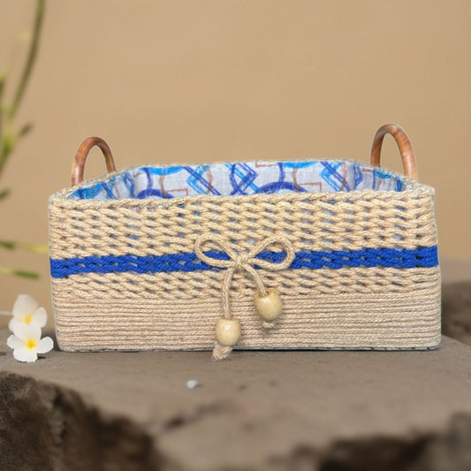 Woven basket with blue accents and wooden handles on a neutral background
